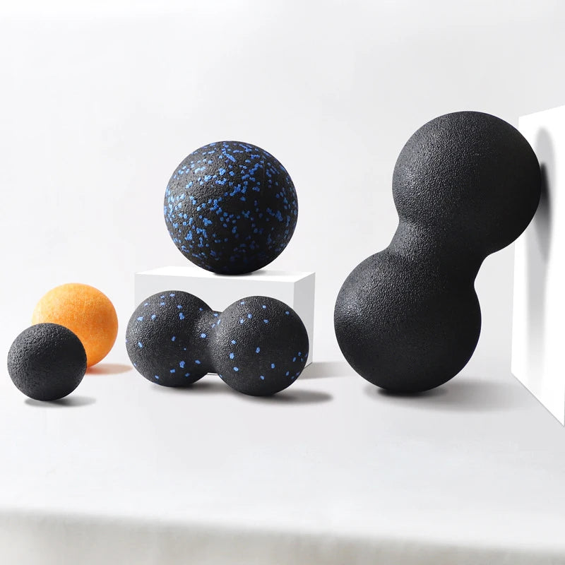 Assorted massage balls and double lacrosse balls for myofascial relief on white background