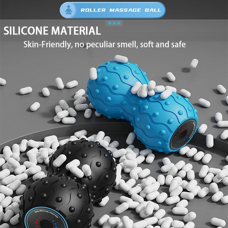 Blue and black silicone roller massage balls on a gray surface with scattered white pellets.